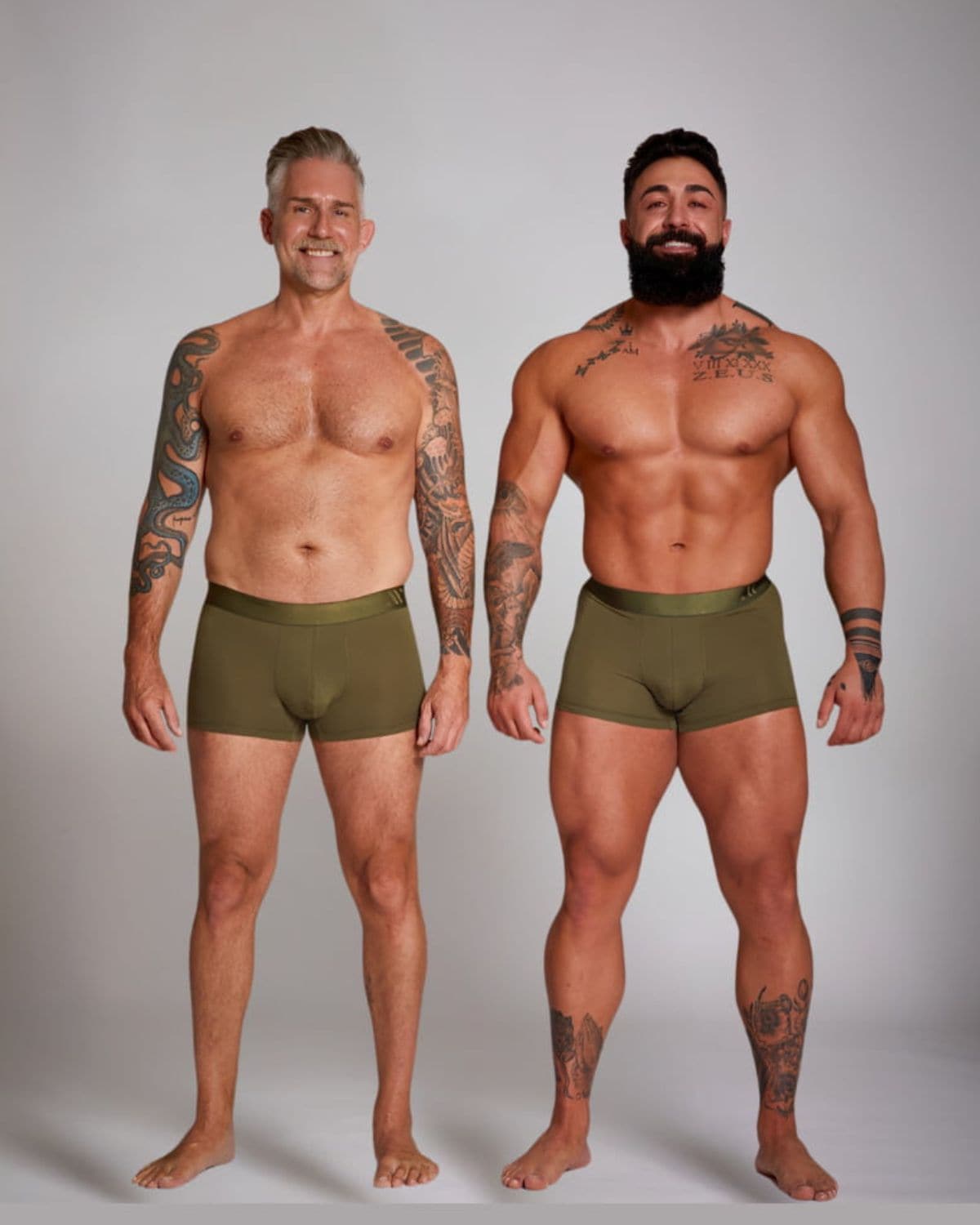 Two men wearing olive green boxer briefs against a plain background