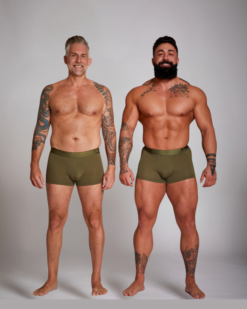 Two men wearing olive green boxer briefs against a plain background