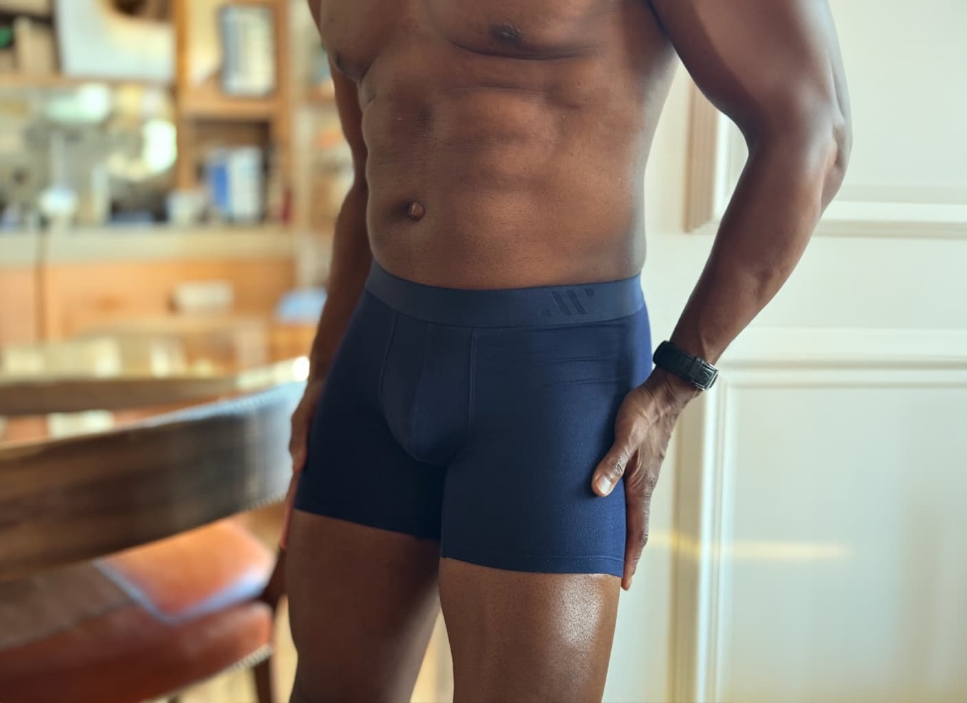Man in ALPHX navy boxer briefs