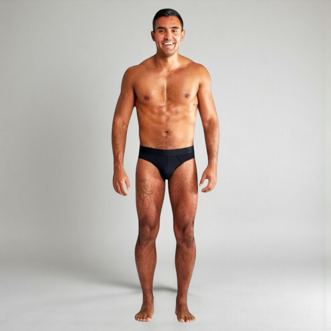 Man wearing ALPHX black BRIEFS SIZE SMALL against a plain background