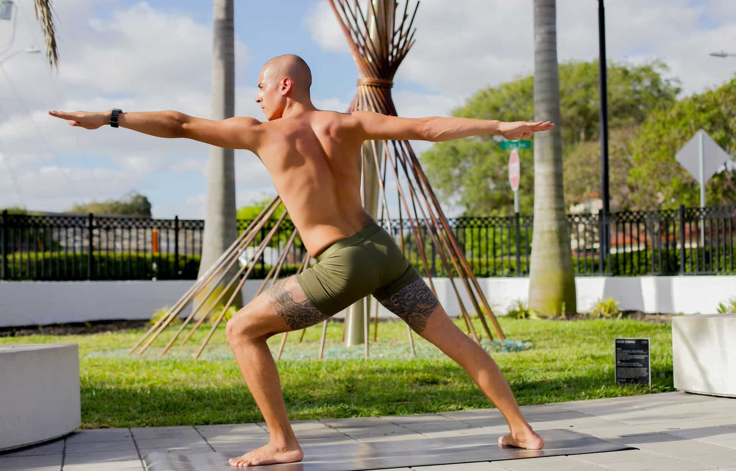 Man in yoga pose wearing ALPHX Boxer Briefs in Moss Green with Four-way Stretch