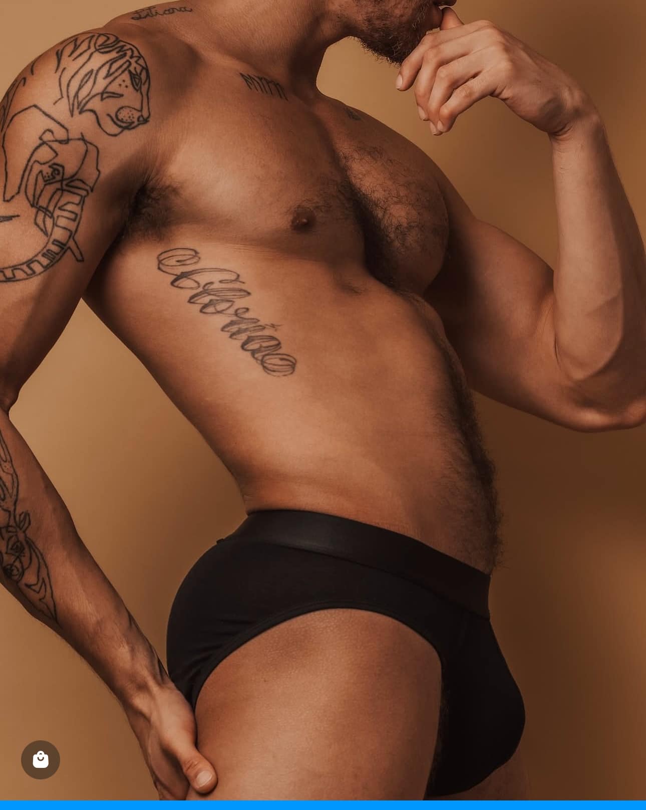 Man with tattoos wearing ALPHX black briefs