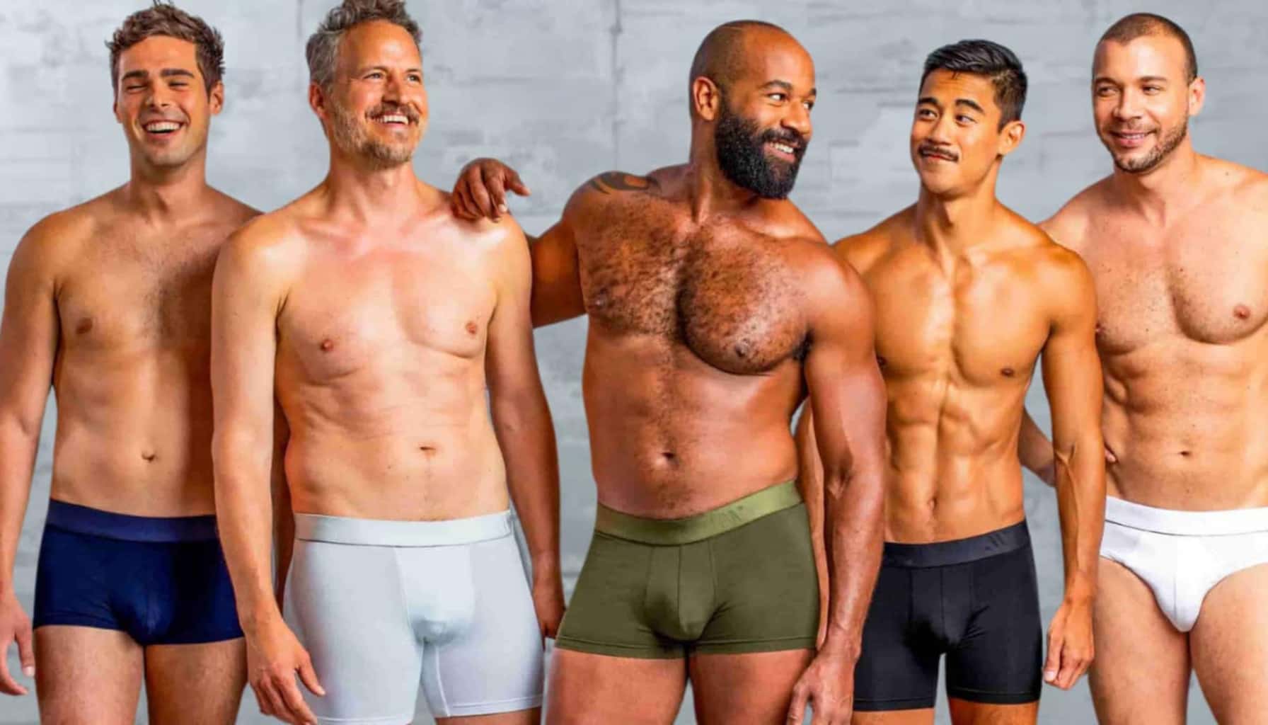 Five men wearing underwear against a gray background