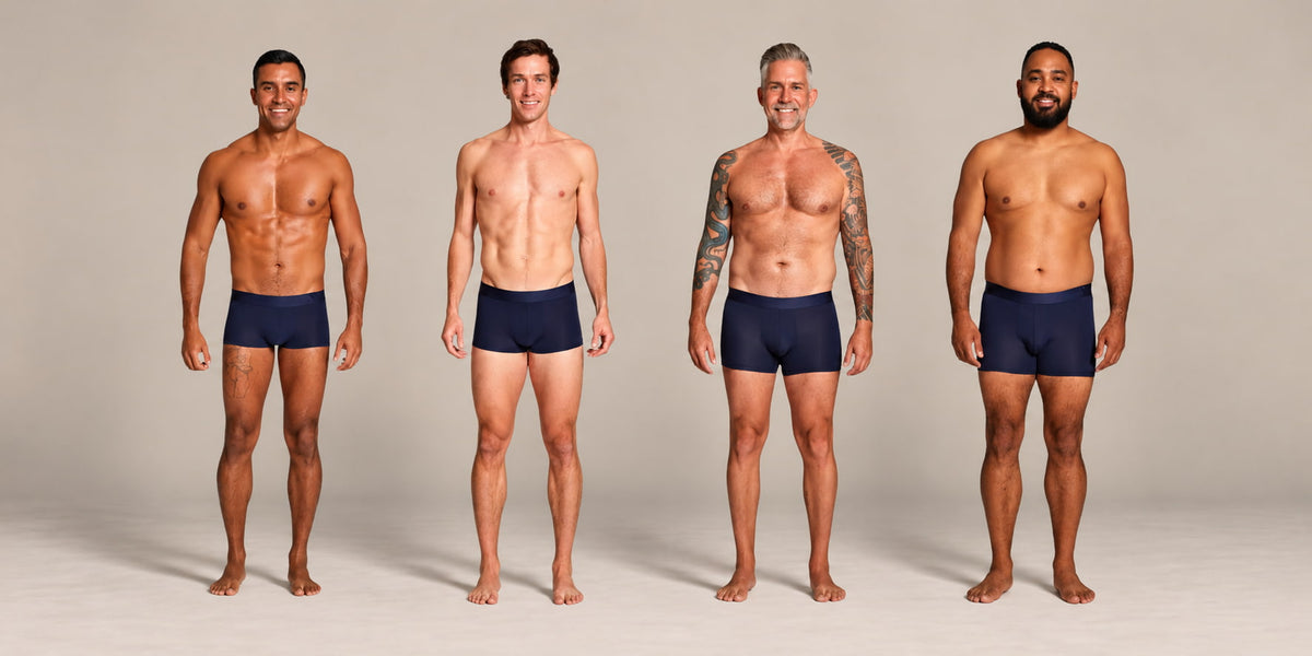Four men standing side by side wearing ALPHX Athletic Fit Trunks, one for each size from S to XL, showing how each waist size fits different body types
